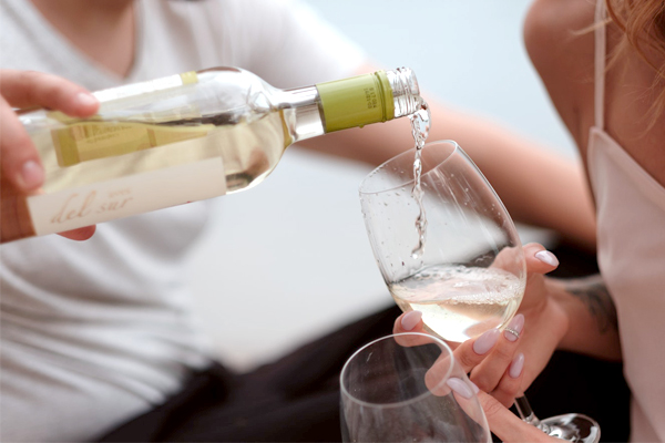 Engagement Party - Pouring White Wine Into Glass