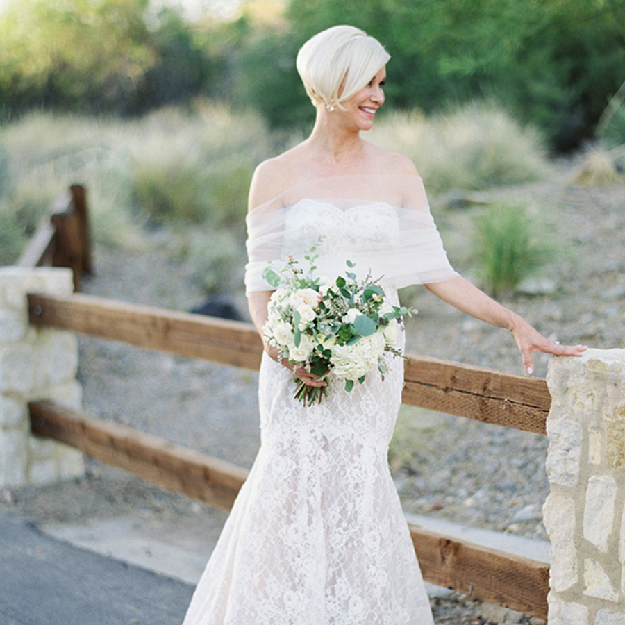 Bridal Style For Older Brides - Woman With Bouquet Next To A Fence